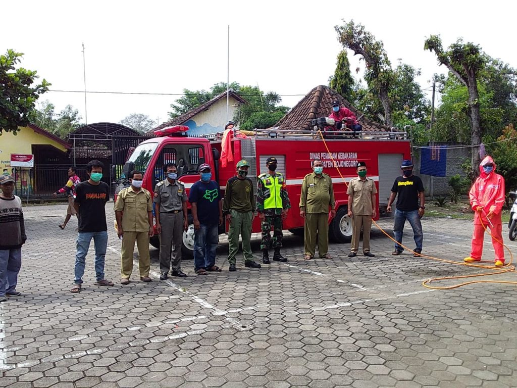 Kades Begadon, H Hariyono, bersama Gugus Desa saat menerima bantuan penyemprotan disinfektan dari Dinas Damkar Bojonegoro.